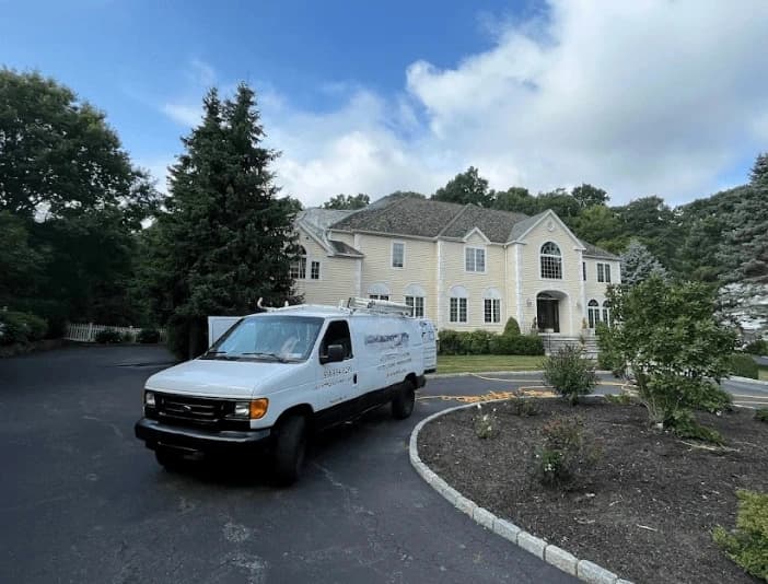 Tallmadge Power Washing technician performing thorough gutter cleaning service in Tallmadge